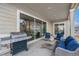 Cozy outdoor patio with comfortable seating, grill, and large sliding glass doors at 8440 Rush Creek Ave, Littleton, CO 80125