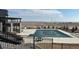A community pool with a large deck area for lounging and beautiful landscape views in the background at 8440 Rush Creek Ave, Littleton, CO 80125