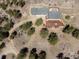 An aerial view shows the spacious deck with fire pit, fenced yard and surrounding wooded property at 351 N Saddle Dr, Idaho Springs, CO 80452