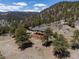 Breathtaking aerial view of a mountain home featuring a spacious deck and a detached garage at 351 N Saddle Dr, Idaho Springs, CO 80452