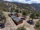 Expansive aerial view showcasing the mountain home, surrounding landscape, and multiple outbuildings at 351 N Saddle Dr, Idaho Springs, CO 80452