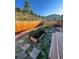 Serene backyard with raised garden beds, stone pathways, and a wooden privacy fence at 351 N Saddle Dr, Idaho Springs, CO 80452