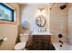 Bathroom with neutral tile and wooden accents, including a vanity, shower, and toilet at 351 N Saddle Dr, Idaho Springs, CO 80452