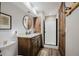 Modern bathroom with a single vanity, framed mirror, and tiled shower, providing a clean and functional space at 351 N Saddle Dr, Idaho Springs, CO 80452
