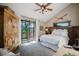 Bedroom with a door to a balcony, a ceiling fan, and rustic decorative skiis on the wall at 351 N Saddle Dr, Idaho Springs, CO 80452