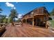 Expansive wooden deck with outdoor seating, grill, and scenic views of the surrounding landscape at 351 N Saddle Dr, Idaho Springs, CO 80452