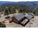 Charming mountain home featuring a spacious deck, fenced yard, and stunning panoramic views of the surrounding landscape at 351 N Saddle Dr, Idaho Springs, CO 80452