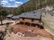 Aerial view of a home with a large deck, a fire pit, an outdoor grill, and mountain views at 351 N Saddle Dr, Idaho Springs, CO 80452