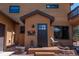 Charming front entrance with a decorative metal art piece, a barrel planter, and a cozy chair at 351 N Saddle Dr, Idaho Springs, CO 80452