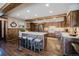 Charming kitchen features an island with seating and modern appliances, creating a warm and inviting space at 351 N Saddle Dr, Idaho Springs, CO 80452