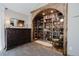 Cozy library nook with custom wooden shelving, decor, and a comfortable green chair at 351 N Saddle Dr, Idaho Springs, CO 80452