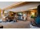 Cozy living room with wood-paneled walls, comfortable seating, and a fireplace, perfect for relaxation at 351 N Saddle Dr, Idaho Springs, CO 80452