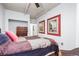 Cozy bedroom featuring a comfortable bed, city-themed wall art, and ample closet space at 444 17Th St # 603, Denver, CO 80202