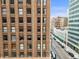 Urban landscape featuring a brick building next to the city street at 444 17Th St # 603, Denver, CO 80202