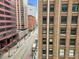 Urban scene highlighting the brick building next to the city street at 444 17Th St # 603, Denver, CO 80202