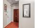 Hallway with hardwood floors, white door, brown closet, and mirror at Midland Lofts at 444 17Th St # 603, Denver, CO 80202