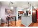 Well-lit kitchen with modern lighting, dark wood cabinets, stainless steel appliances, and a breakfast bar at 444 17Th St # 603, Denver, CO 80202