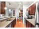 Updated kitchen featuring stainless steel appliances, dark wood cabinets, and modern fixtures at 444 17Th St # 603, Denver, CO 80202