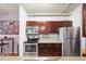 Well-equipped kitchen featuring modern stainless steel appliances, dark wood cabinets, and a breakfast bar at 444 17Th St # 603, Denver, CO 80202