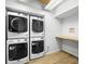 Efficient laundry room with stacked washer and dryer units and countertop at 444 17Th St # 603, Denver, CO 80202