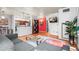 Open-concept living room showing hardwood floors, exposed ceiling, a gray couch, and a glimpse of the kitchen at 444 17Th St # 603, Denver, CO 80202