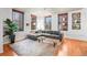 Bright living room featuring hardwood floors, large windows, and a comfortable gray sofa at 444 17Th St # 603, Denver, CO 80202