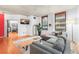 Bright living room with hardwood floors, large windows, a gray couch, and a decorative rug at 444 17Th St # 603, Denver, CO 80202