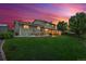 Expansive backyard with well-maintained lawn, patio, and charming outdoor dining area perfect for entertaining at 13266 Canopus Dr, Lone Tree, CO 80124