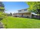Well-manicured backyard with lush green lawn and covered patio offers a perfect setting for outdoor enjoyment at 13266 Canopus Dr, Lone Tree, CO 80124