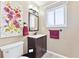 Charming bathroom with a vanity sink, decorative art, and modern fixtures at 13266 Canopus Dr, Lone Tree, CO 80124