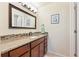 Modern bathroom with granite counters, tile backsplash, updated fixtures, and large dark wood framed mirror at 13266 Canopus Dr, Lone Tree, CO 80124
