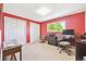 Office area with red wall and carpeted floor, plus workspace and chairs at 13266 Canopus Dr, Lone Tree, CO 80124