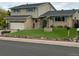 Inviting two-story home with a lush lawn and charming exterior details at 13266 Canopus Dr, Lone Tree, CO 80124