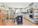 Bright kitchen with stainless steel appliances, a tile backsplash, and a wooden island with seating at 13266 Canopus Dr, Lone Tree, CO 80124
