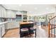 Modern kitchen with island, barstool seating, stainless steel appliances, and open living space at 13266 Canopus Dr, Lone Tree, CO 80124