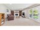 Cozy living room with a fireplace, built-in bookshelves, and sliding glass doors leading to the patio at 13266 Canopus Dr, Lone Tree, CO 80124