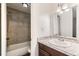 Bathroom with modern vanity, mirror, and tiled shower at 5875 E Iliff Ave # 115, Denver, CO 80222