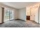 Cozy bedroom with neutral carpeting, bright window, and sliding glass doors at 5875 E Iliff Ave # 115, Denver, CO 80222