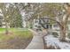 Charming condo building with metal staircase and walkway surrounded by trees and light dusting of snow at 5875 E Iliff Ave # 115, Denver, CO 80222