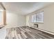 Inviting living room features sleek, gray wood-look flooring and ample natural light at 5875 E Iliff Ave # 115, Denver, CO 80222
