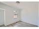 Simple bedroom with large window and light-grey flooring at 15275 W 68Th Pl, Arvada, CO 80007