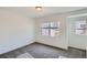 Bright bedroom with neutral walls, gray carpeting, and large windows at 15275 W 68Th Pl, Arvada, CO 80007