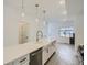 Modern kitchen island with white cabinets and stainless steel appliances at 15275 W 68Th Pl, Arvada, CO 80007