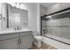 Sparkling bathroom with tub-shower combo, gray vanity, and contemporary fixtures at 180 N Edge Cliff St, Castle Rock, CO 80104