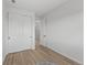Neutral bedroom with double closet, light wood flooring, and bright natural light at 180 N Edge Cliff St, Castle Rock, CO 80104