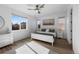 Bright bedroom with large windows, light wood flooring, and a comfortable queen-sized bed at 180 N Edge Cliff St, Castle Rock, CO 80104