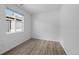 Simple bedroom with window offering natural light, hard wood floors, and neutral coloring at 180 N Edge Cliff St, Castle Rock, CO 80104