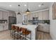 Gourmet kitchen boasts stainless steel appliances, a center island with seating, and stylish pendant lighting at 180 N Edge Cliff St, Castle Rock, CO 80104
