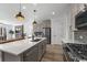 Contemporary kitchen with a large island, stainless steel appliances, and an open design to the living area at 180 N Edge Cliff St, Castle Rock, CO 80104
