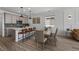 Modern kitchen featuring a center island with barstool seating and an adjacent dining area at 180 N Edge Cliff St, Castle Rock, CO 80104